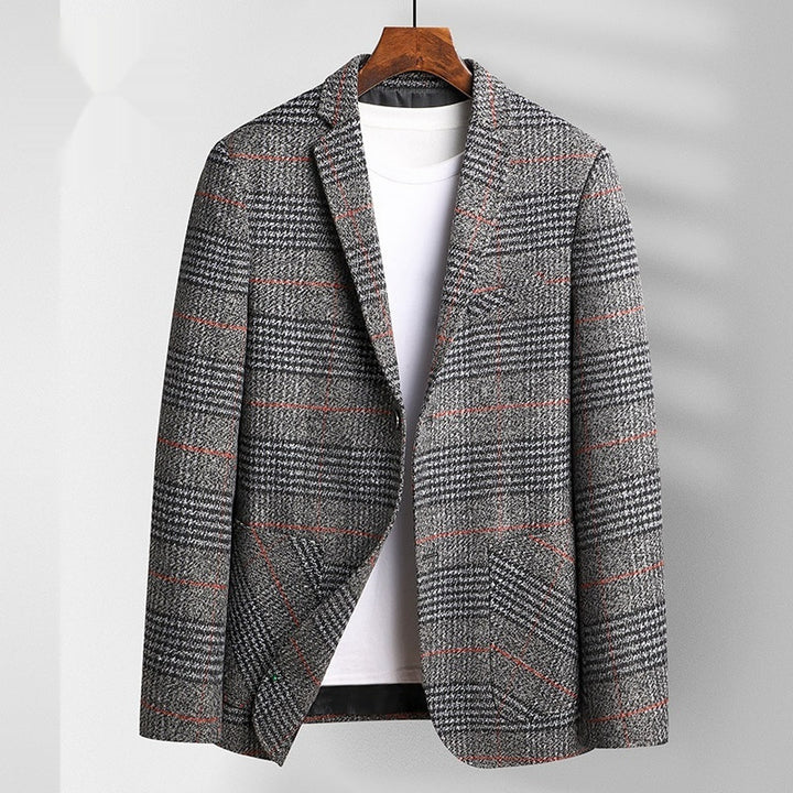 Plaid patterned coat on a hanger against a plain background