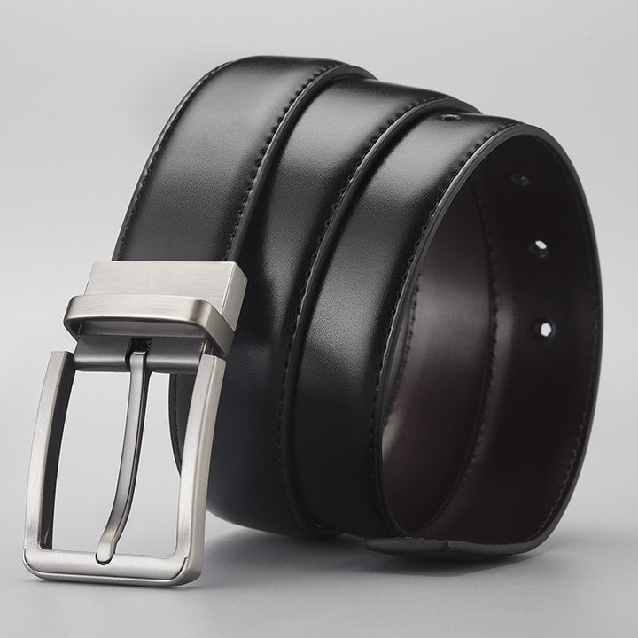 Black leather belt with a silver buckle on a light gray background