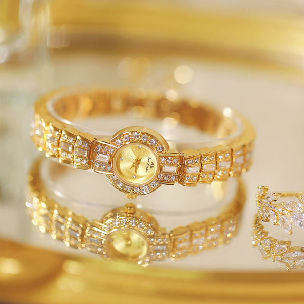 Gold bracelet with diamond accents on a reflective gold surface