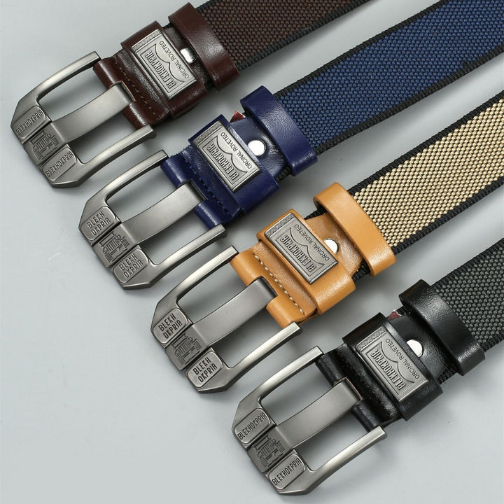 Set of five belts with different color straps and metal buckles on a light gray background.