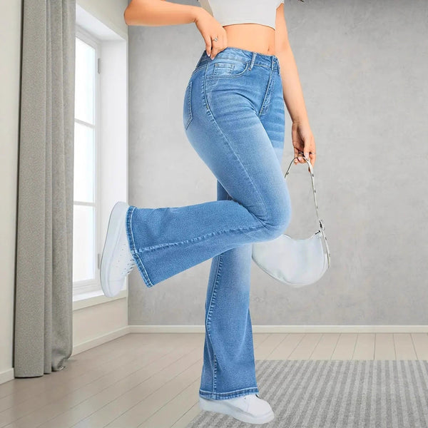 Person wearing blue jeans and white sneakers in a room with a window and gray walls.