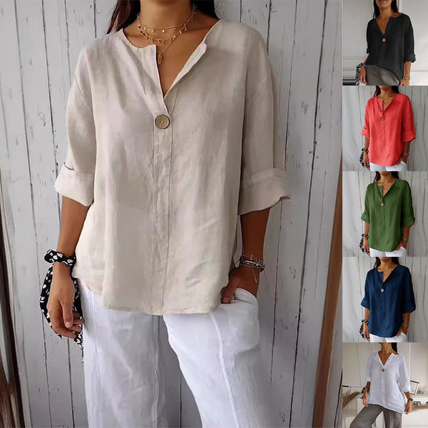 Woman wearing a loose-fit beige V-neck long-sleeve cotton-linen top with buttons, standing against a plain background
